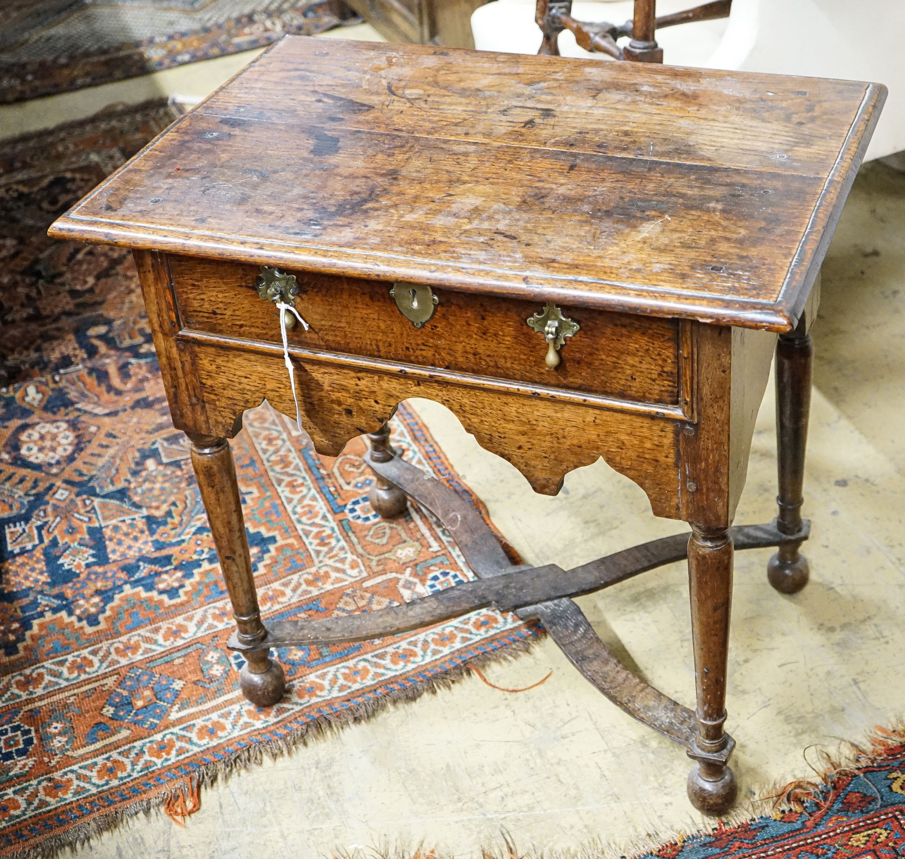 An early 18th century oak lowboy, with single drawer and saltire stretcher, width 67cm, depth 46cm, height 64cm